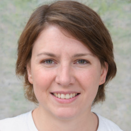 Joyful white young-adult female with medium  brown hair and blue eyes