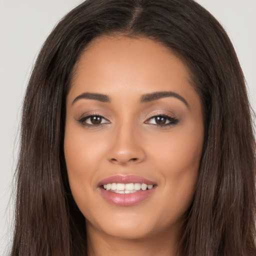 Joyful white young-adult female with long  brown hair and brown eyes