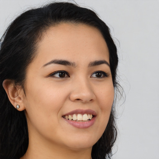 Joyful latino young-adult female with long  black hair and brown eyes