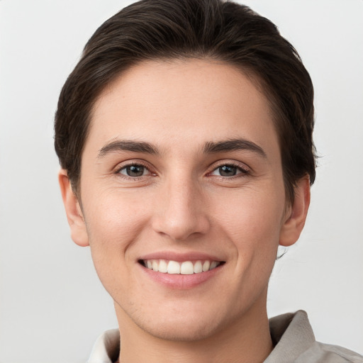 Joyful white young-adult female with short  brown hair and brown eyes