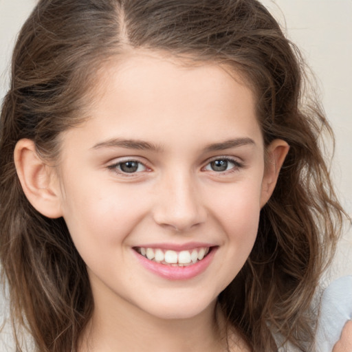 Joyful white child female with medium  brown hair and brown eyes