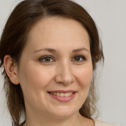 Joyful white adult female with medium  brown hair and brown eyes