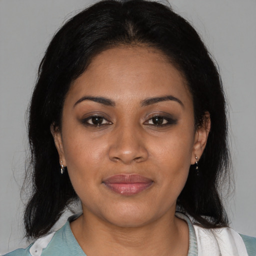 Joyful latino young-adult female with medium  black hair and brown eyes
