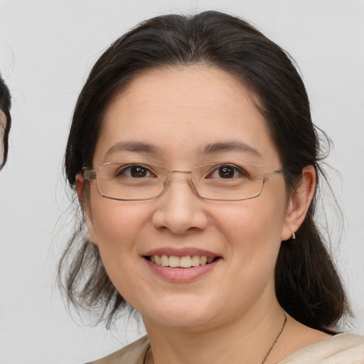 Joyful white adult female with medium  brown hair and brown eyes