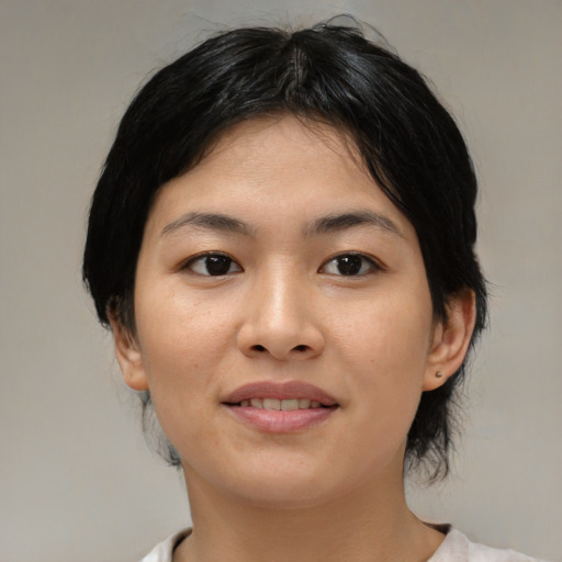 Joyful asian young-adult female with medium  black hair and brown eyes