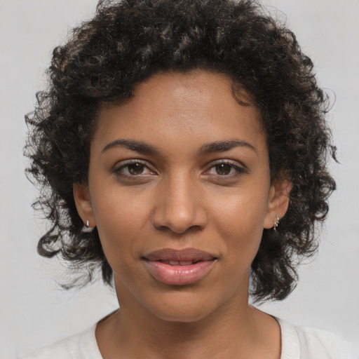 Joyful black young-adult female with medium  brown hair and brown eyes
