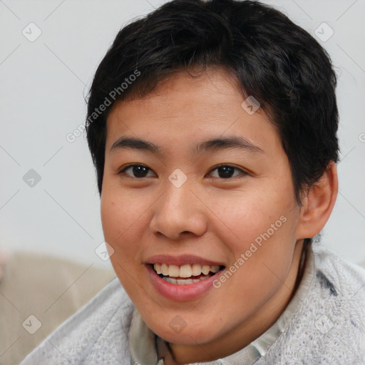 Joyful asian young-adult female with short  brown hair and brown eyes