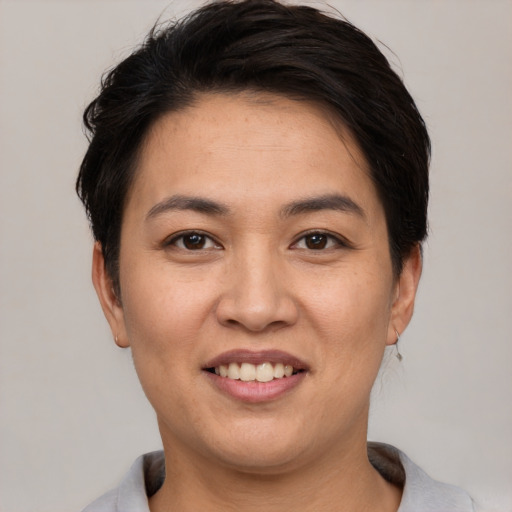 Joyful white young-adult female with short  black hair and brown eyes