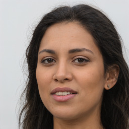 Joyful latino young-adult female with long  brown hair and brown eyes