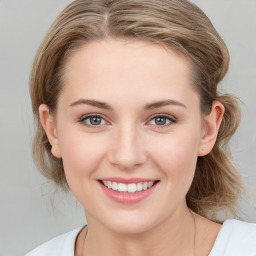 Joyful white young-adult female with medium  brown hair and blue eyes