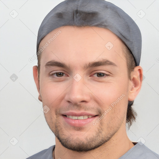 Joyful white young-adult male with short  black hair and brown eyes