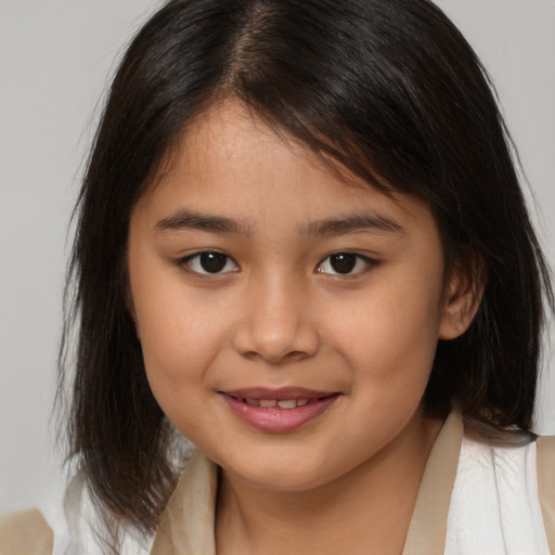 Joyful asian child female with medium  brown hair and brown eyes