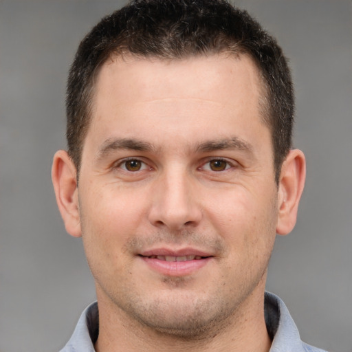 Joyful white young-adult male with short  brown hair and brown eyes