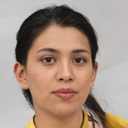 Joyful latino young-adult female with medium  brown hair and brown eyes