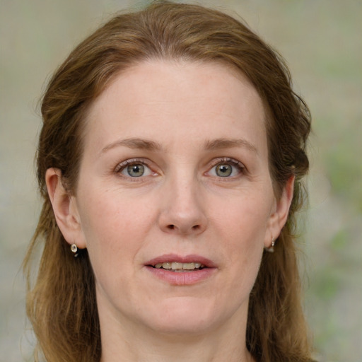 Joyful white adult female with medium  brown hair and blue eyes