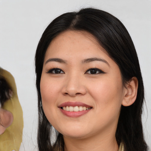 Joyful asian young-adult female with medium  black hair and brown eyes