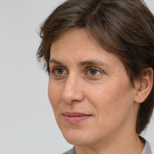 Joyful white adult female with medium  brown hair and grey eyes