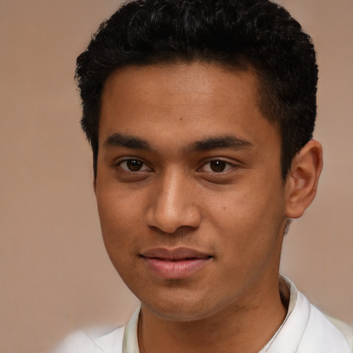 Joyful latino young-adult male with short  brown hair and brown eyes