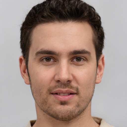 Joyful white young-adult male with short  brown hair and brown eyes