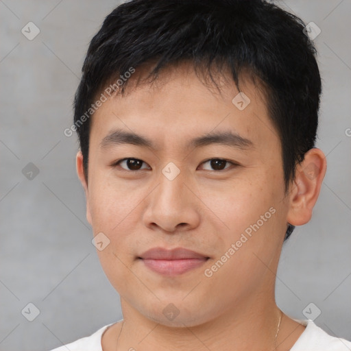 Joyful asian young-adult male with short  brown hair and brown eyes