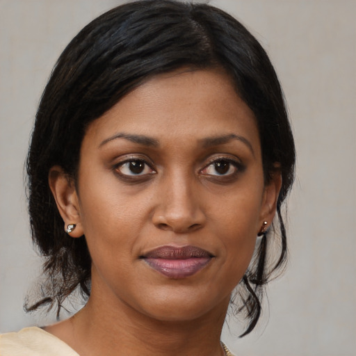 Joyful black young-adult female with medium  brown hair and brown eyes