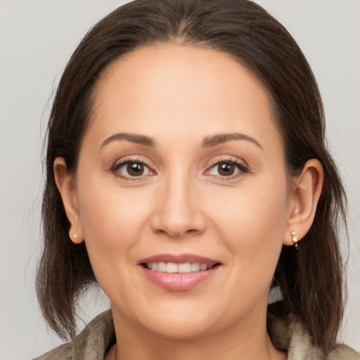 Joyful white young-adult female with medium  brown hair and brown eyes