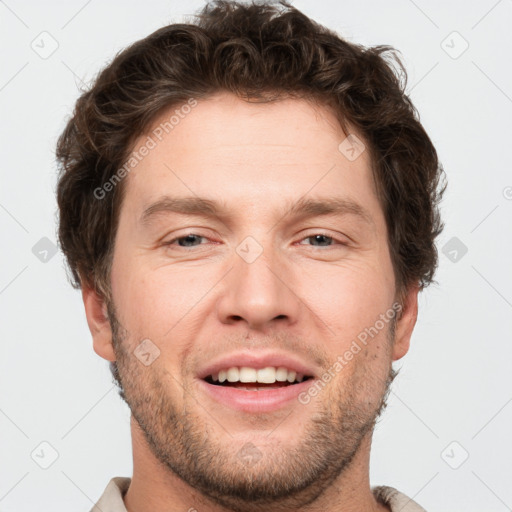 Joyful white adult male with short  brown hair and grey eyes