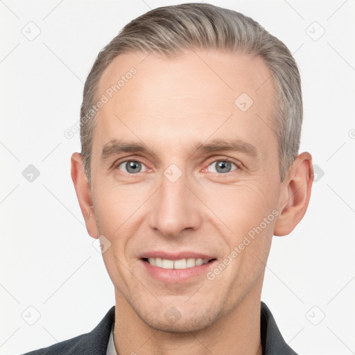 Joyful white adult male with short  brown hair and grey eyes