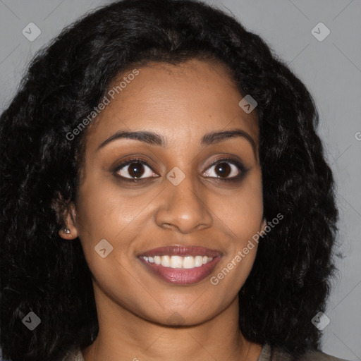 Joyful black young-adult female with long  brown hair and brown eyes