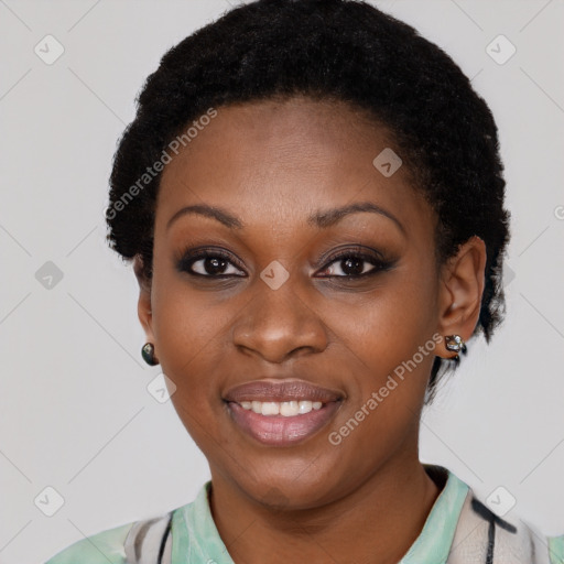 Joyful black young-adult female with short  black hair and brown eyes