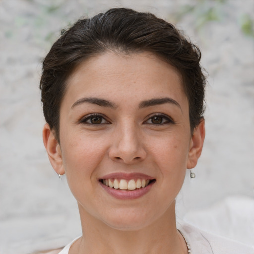 Joyful white young-adult female with short  brown hair and brown eyes
