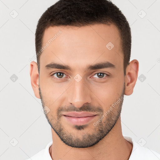 Joyful white young-adult male with short  brown hair and brown eyes