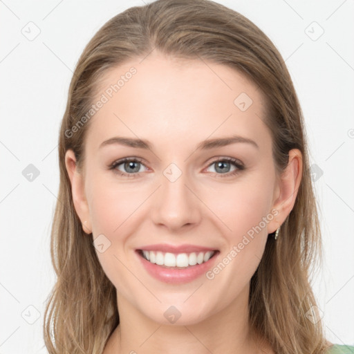 Joyful white young-adult female with long  brown hair and grey eyes