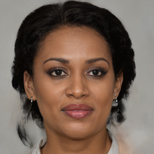 Joyful black young-adult female with medium  brown hair and brown eyes