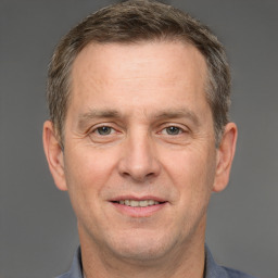 Joyful white adult male with short  brown hair and brown eyes