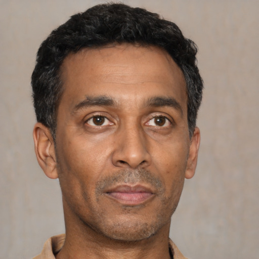 Neutral latino adult male with short  black hair and brown eyes