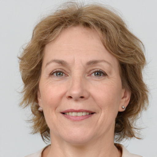 Joyful white adult female with medium  brown hair and grey eyes