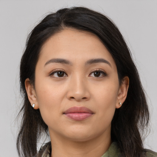 Joyful latino young-adult female with medium  brown hair and brown eyes