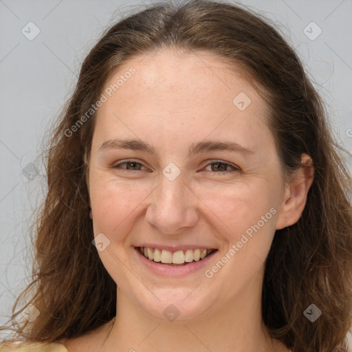 Joyful white adult female with long  brown hair and brown eyes