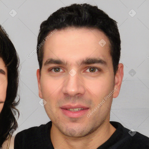 Joyful white young-adult male with short  black hair and brown eyes