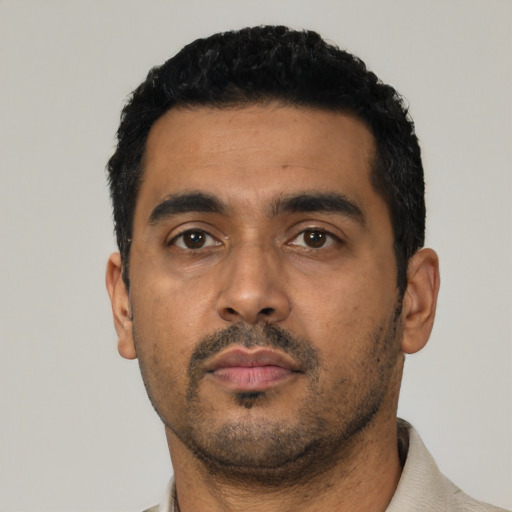 Neutral latino young-adult male with short  black hair and brown eyes