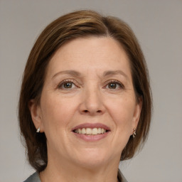 Joyful white adult female with medium  brown hair and grey eyes