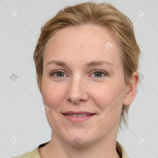 Joyful white adult female with medium  brown hair and grey eyes