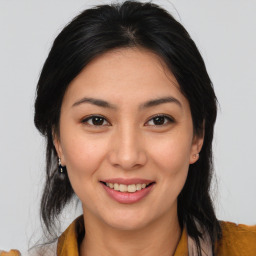 Joyful latino young-adult female with medium  brown hair and brown eyes