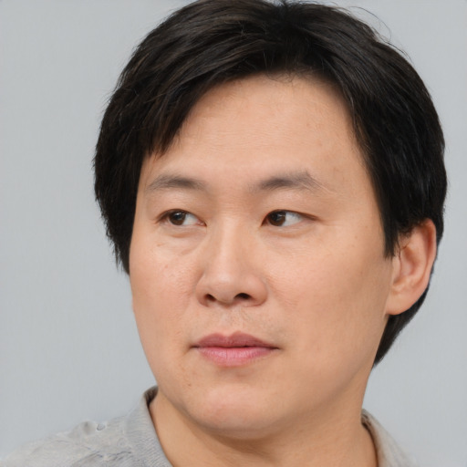 Neutral asian adult male with short  brown hair and brown eyes