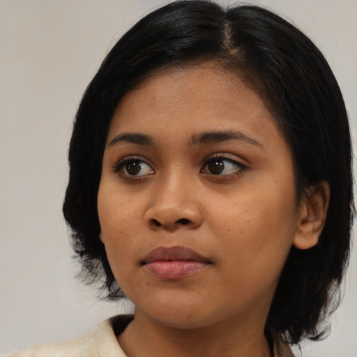 Joyful asian young-adult female with medium  black hair and brown eyes