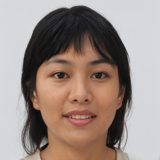 Joyful asian young-adult female with medium  brown hair and brown eyes