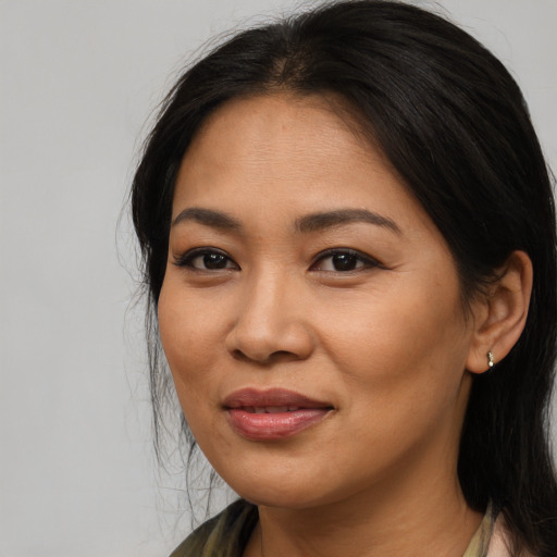 Joyful asian young-adult female with medium  brown hair and brown eyes