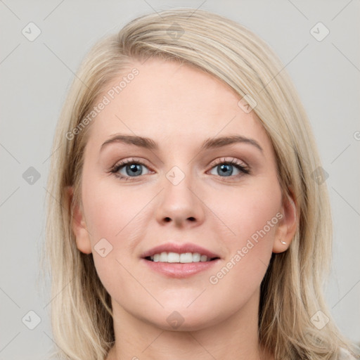 Joyful white young-adult female with long  brown hair and blue eyes