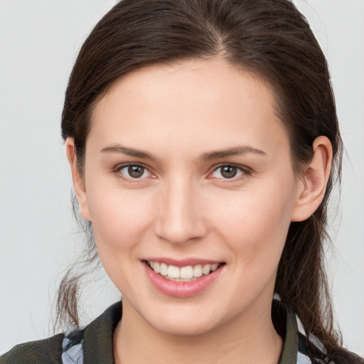 Joyful white young-adult female with medium  brown hair and brown eyes